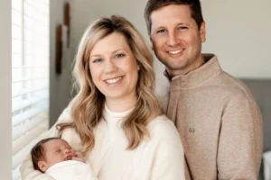 Couple holding newborn baby after successful fertility journey with PREG fertility specialists in Charleston
