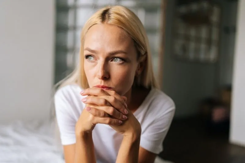 Woman reflecting during her fertility journey and exploring infertility support with PREG