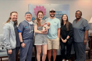 PREG fertility doctor and care team with patients and their baby at the Mount Pleasant fertility clinic