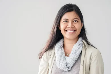 Smiling young woman looking directly at camera, empowered by fertility preservation