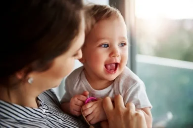 Woman holding and looking at her baby after donor sperm treatment journey