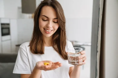 Woman taking preconception and prenatal vitamins for fertility support